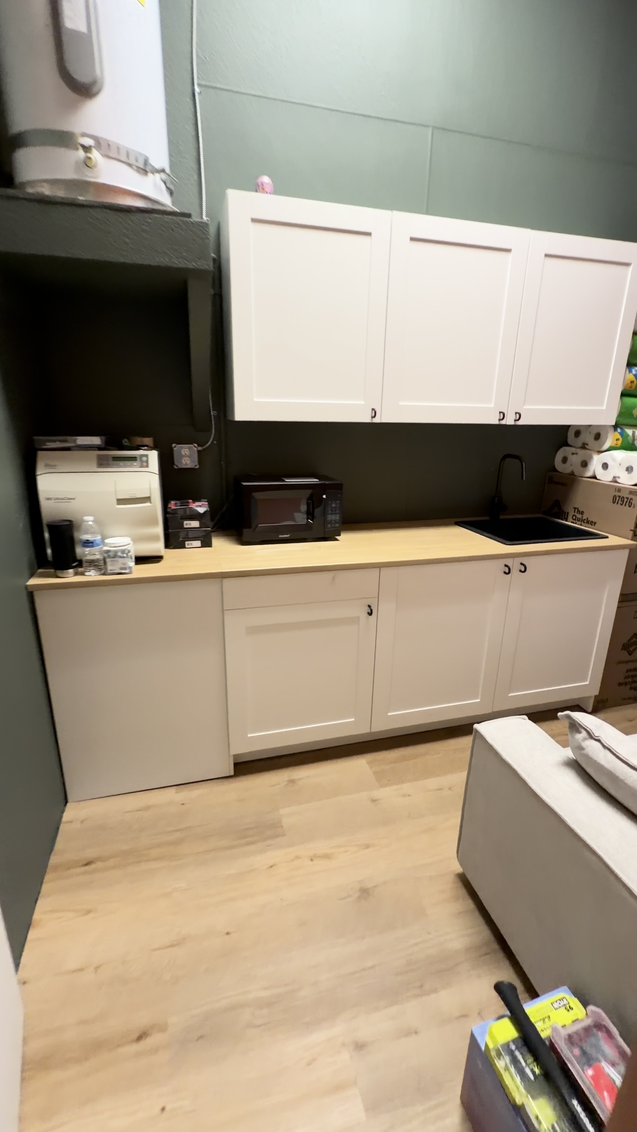 Completed white base and wall cabinets with a wood countertop