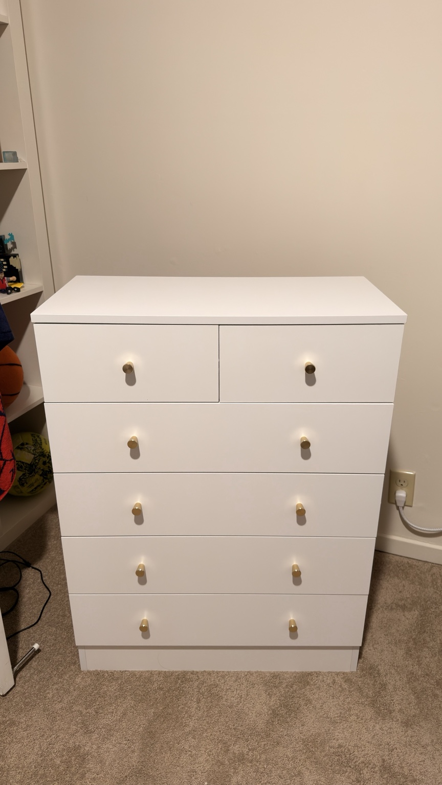 White assembled dresser with gold-tone knobs