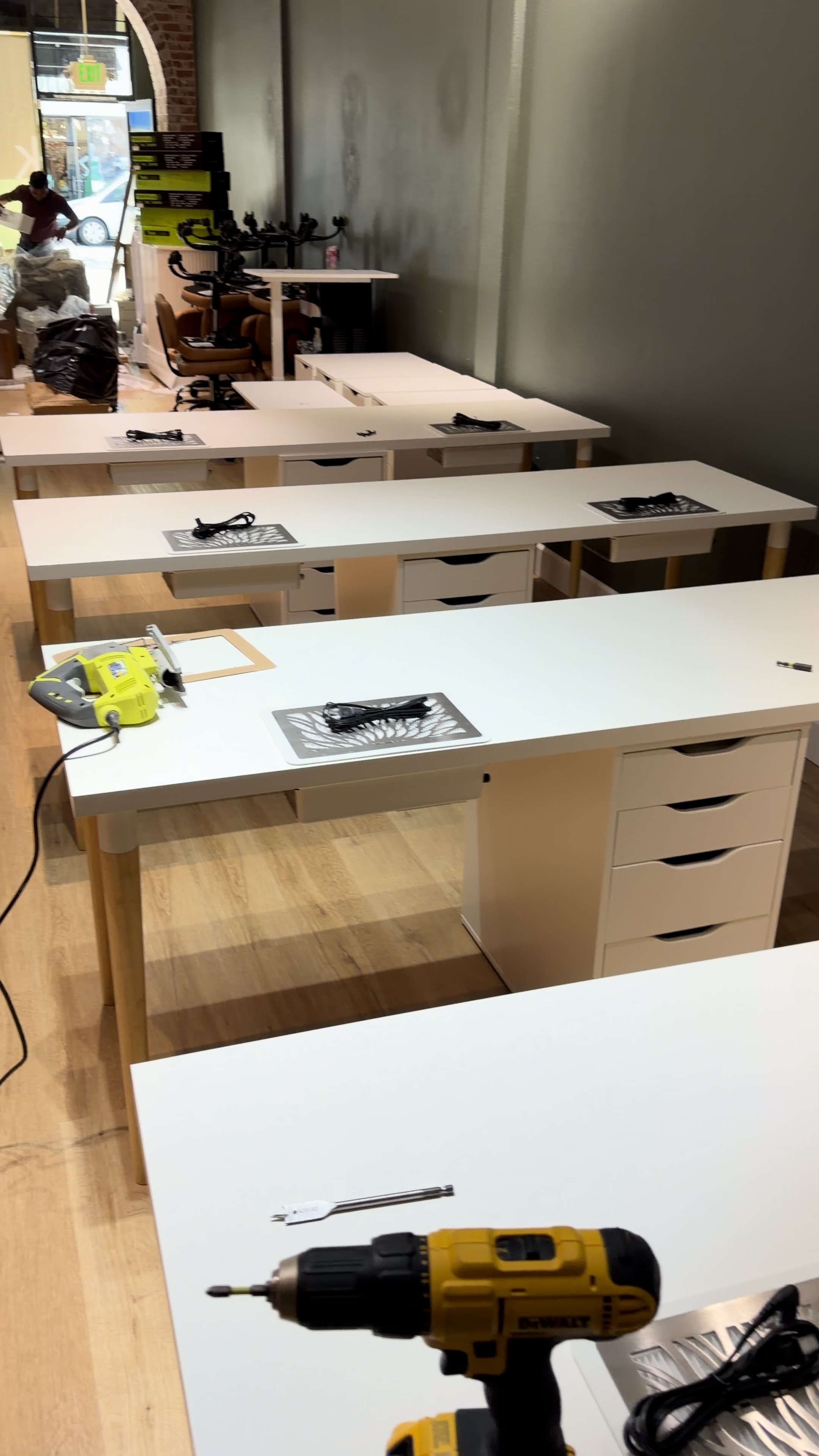Rows of assembled white salon desks and drawers